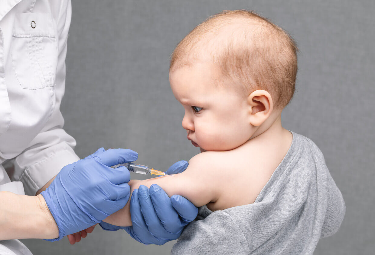Doctor vaccinating child
